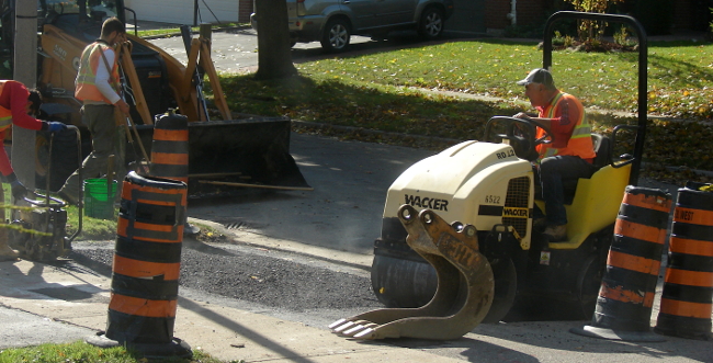 Boulevard repaving, Toronto, Canada. The boulevard asphalt on my neighbours house is compressed by a roller machine. Photo7 by Don Tai